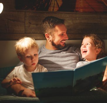 evening family reading. father reads children . book before going to bed