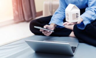 loan-planing-for-new-home-concept-businesswoman-holding-home-model-and-mobile-with-laptop-on-bed-at_t20_vKznWv (1)