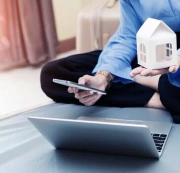 loan-planing-for-new-home-concept-businesswoman-holding-home-model-and-mobile-with-laptop-on-bed-at_t20_vKznWv (1)